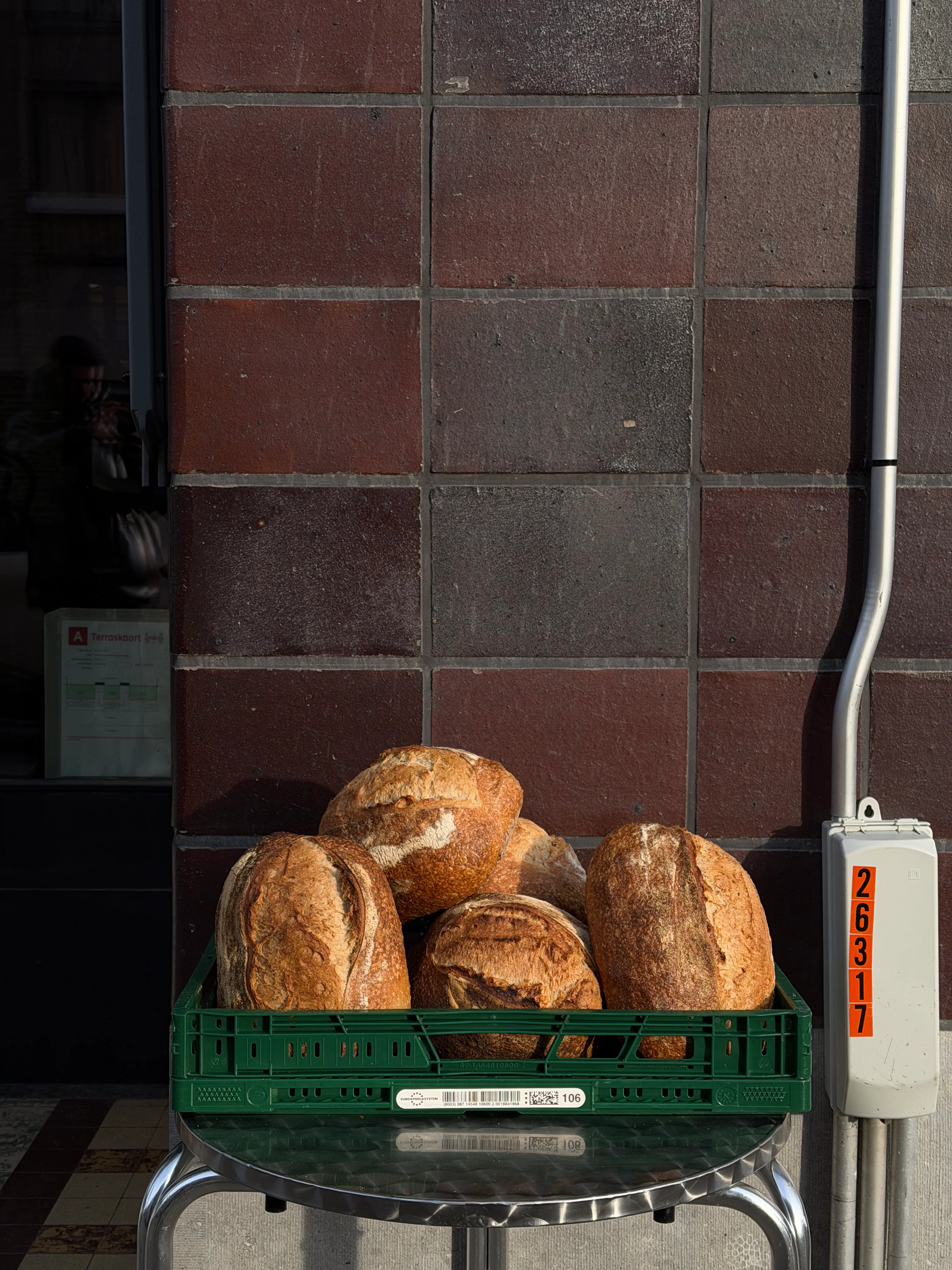 Miso sourdough loaves in a green crate